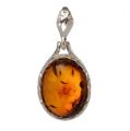 Genuine Baltic honey amber oval pendant in 925 sterling silver with natural fossil inclusions, handcrafted European amber jewelry with polished silver bail on white background