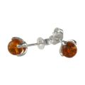 Sadie genuine Baltic honey amber stud earrings in 925 sterling silver with petal-style prong setting and post back closure, handmade Polish amber jewelry for women on white background