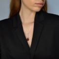 Model wearing a genuine Baltic amber open rose pendant necklace in 925 sterling silver on an 18” chain, shown styled with a black blazer.