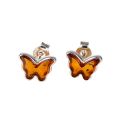 Genuine Baltic honey amber butterfly stud earrings in 925 sterling silver, handmade Polish post back earrings with natural amber stones on white background