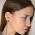 Model wearing genuine Baltic honey amber stud earrings in solid 925 sterling silver, showing natural fit and size on ear with close-up detail
