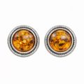 Pair of genuine Baltic honey amber stud earrings in oxidized 925 sterling silver, round cabochon amber stones with natural inclusions on white background