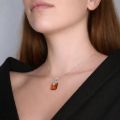 Genuine Baltic amber pendant necklace in 925 sterling silver worn by model, showcasing honey amber stone and elegant everyday style